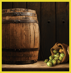 Beer Mug With Wheat And Hops In Cellar With Barrel
