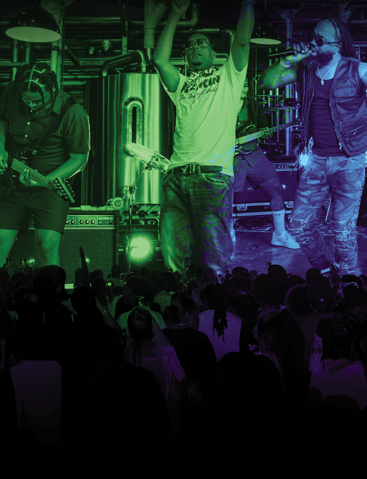 A group of people are standing on stage in front of a crowd. Description generated by AI